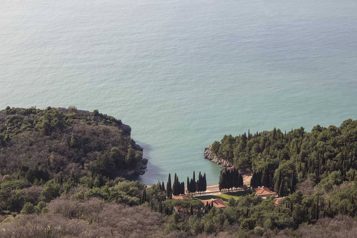 The view of one of the most beautiful beaches in Montenegro - in Budva. It is surrounded with many trees and its secluded.